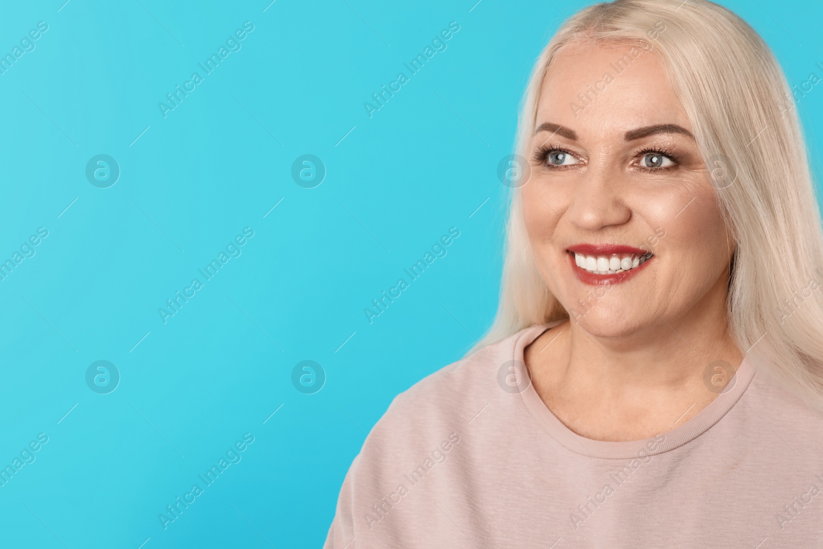 Photo of Smiling woman with perfect teeth on color background. Space for text