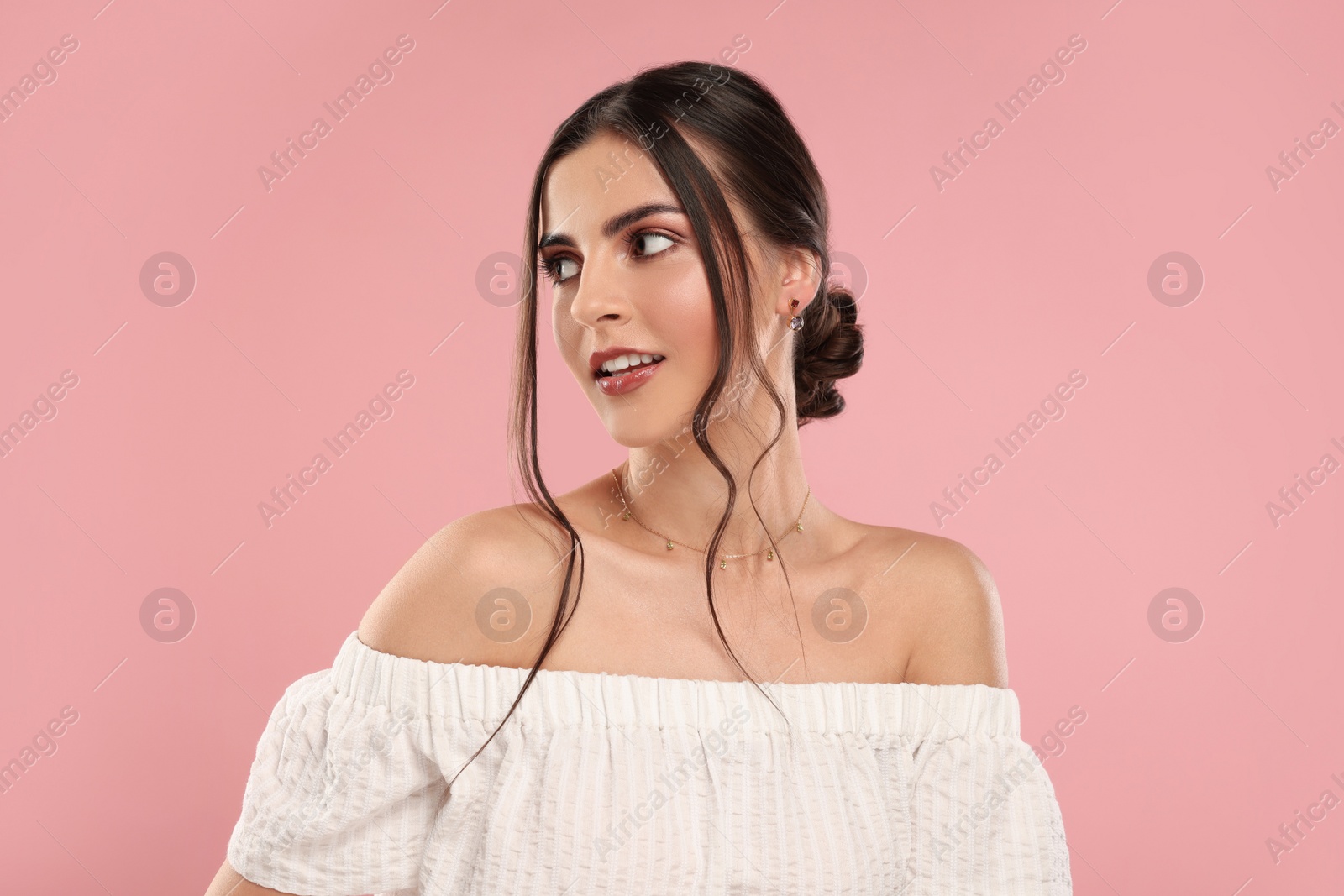 Photo of Beautiful woman with elegant jewelry on pink background