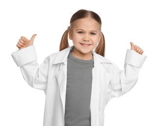 Photo of Little girl in medical uniform showing thumbs up on white background