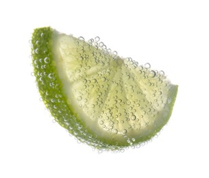 Slice of lime in sparkling water on white background. Citrus soda