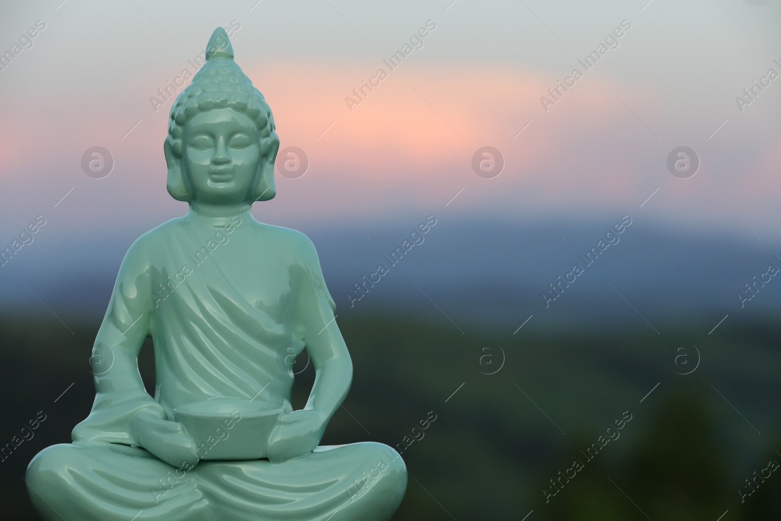 Photo of Decorative Buddha statue in mountains. Space for text