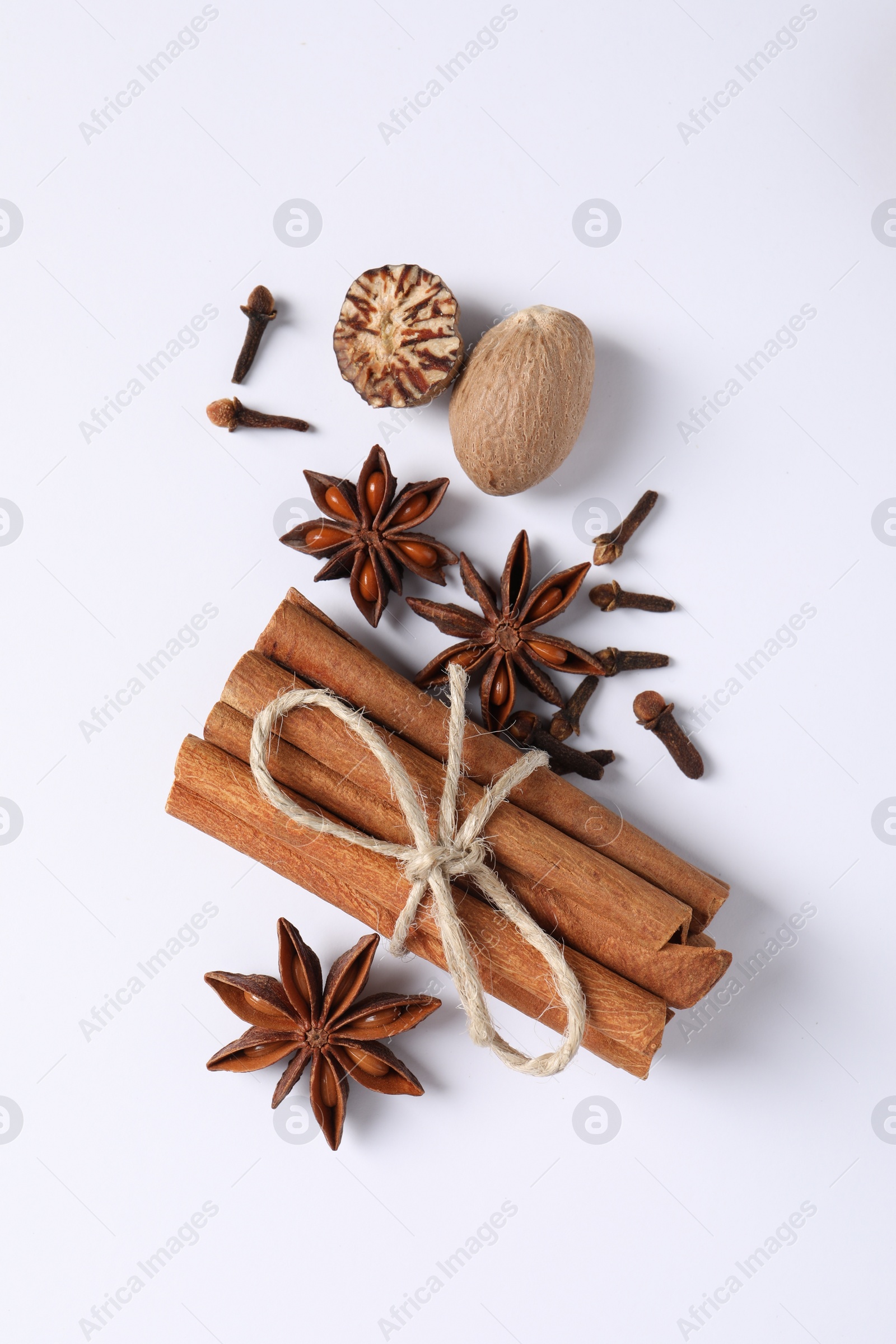 Photo of Different spices and nuts on white background, flat lay