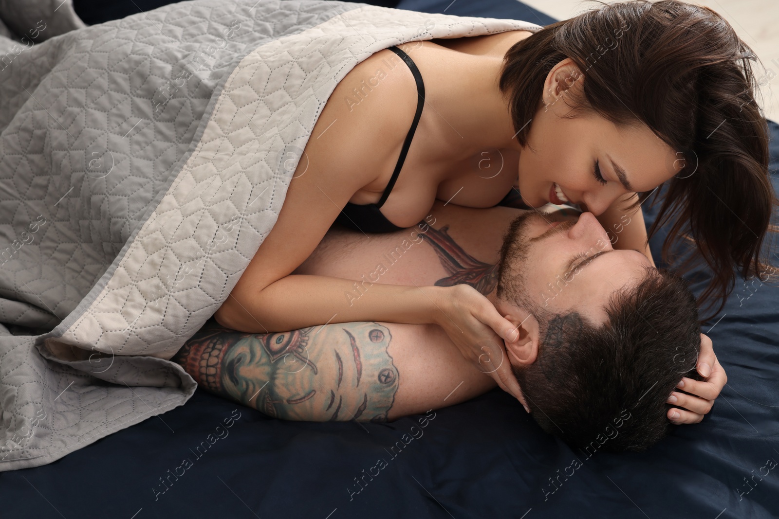 Photo of Passionate young couple having sex on bed