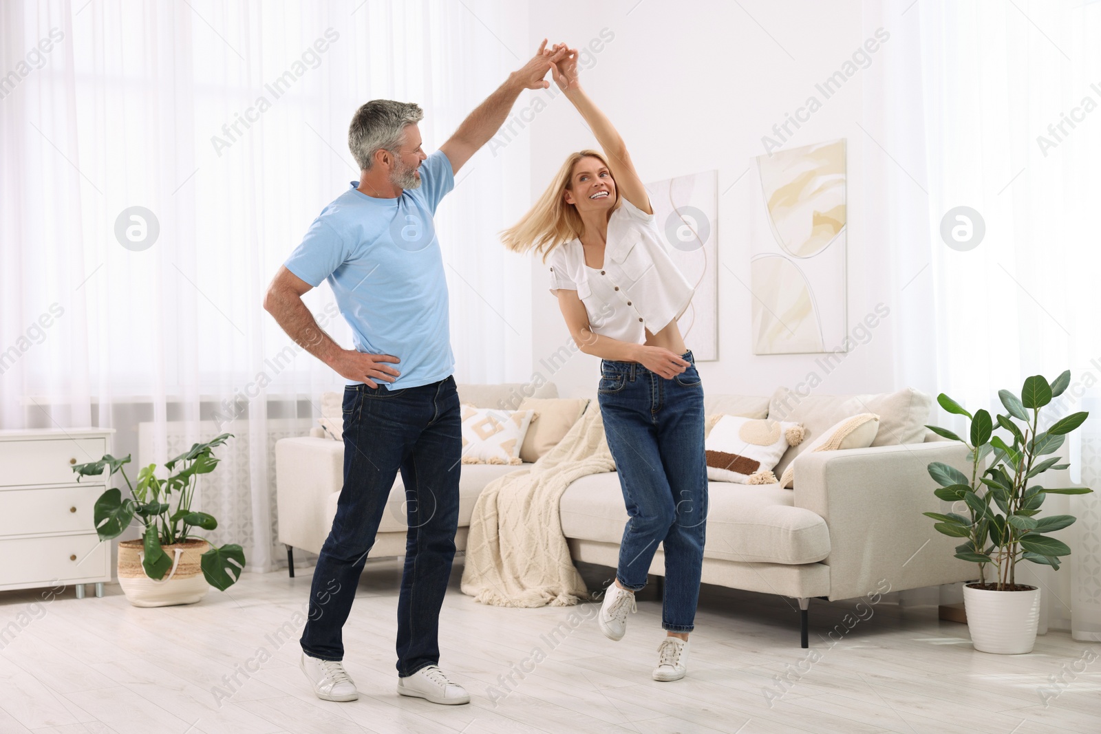 Photo of Happy affectionate couple dancing at home. Romantic date