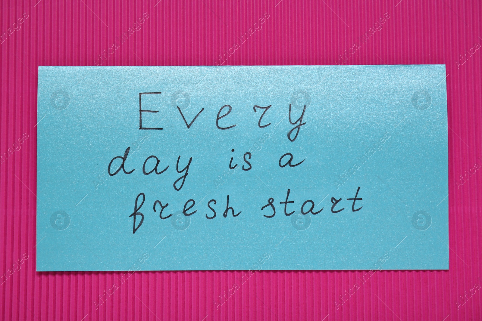 Photo of Card with phrase Every Day Is A Fresh Start on pink background, top view. Motivational quote