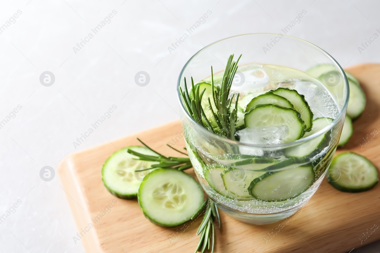 Photo of Glass of fresh cucumber water on table. Space for text