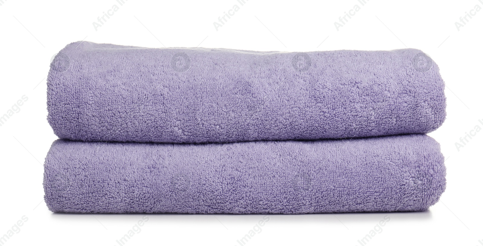 Photo of Folded soft terry towels on white background