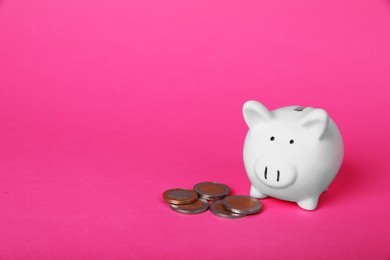 Photo of Ceramic piggy bank and coins on pink background, space for text. Financial savings