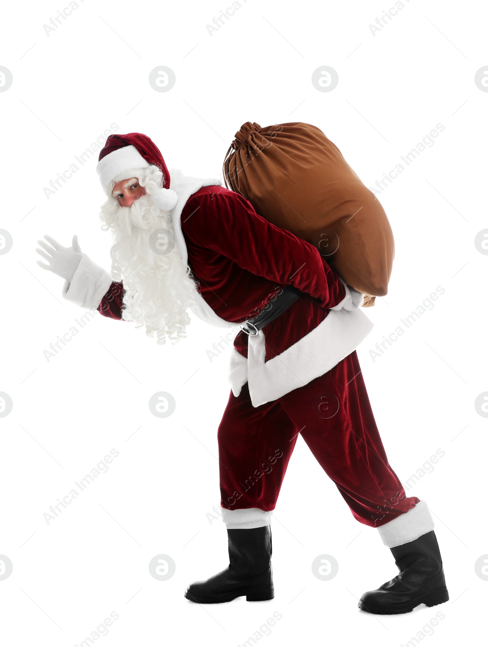 Photo of Santa Claus with sack walking on white background
