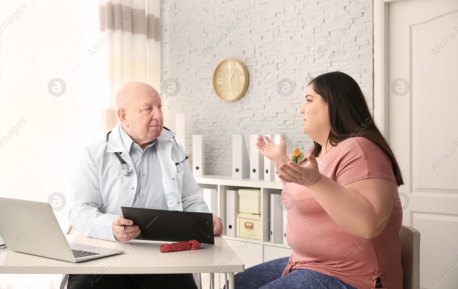 Photo of Overweight woman having consultation at doctor's office