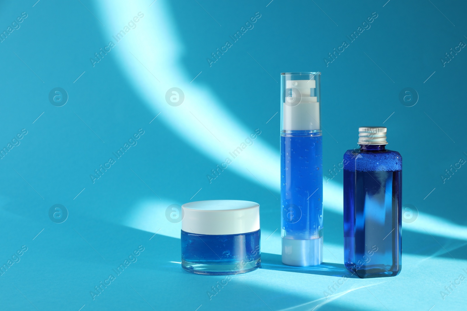 Photo of Set of luxury cosmetic products on light blue background. Space for text