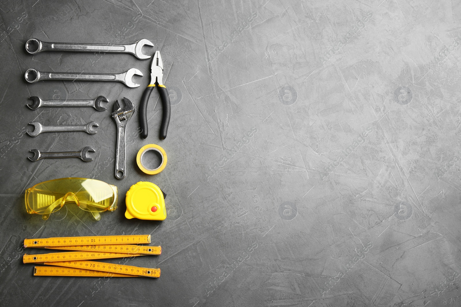 Photo of Flat lay composition with construction tools on grey background, space for text