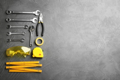 Photo of Flat lay composition with construction tools on grey background, space for text