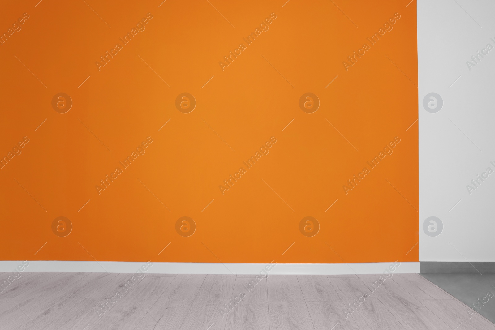 Photo of Empty renovated room with white and orange walls