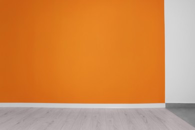 Empty renovated room with white and orange walls