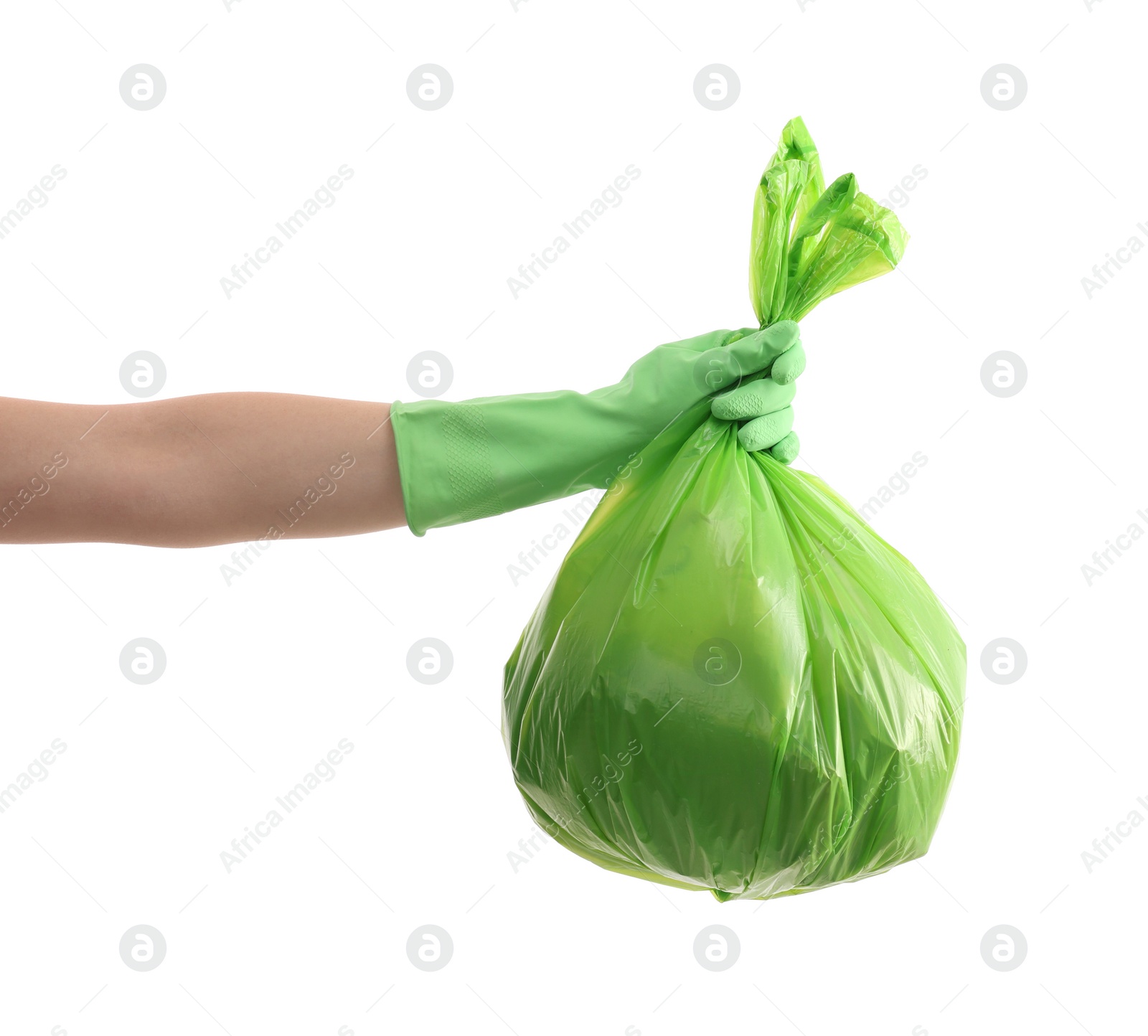 Photo of Woman holding plastic bag full of garbage on white background, closeup