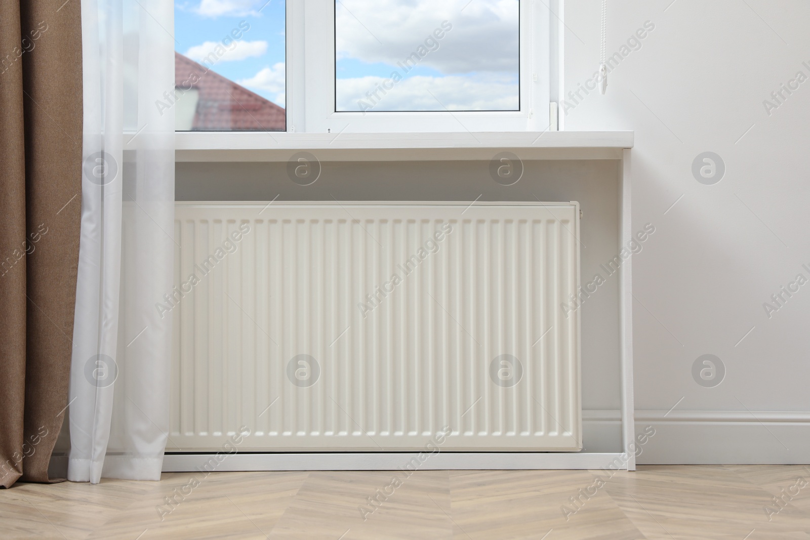 Photo of Modern radiator at home. Central heating system