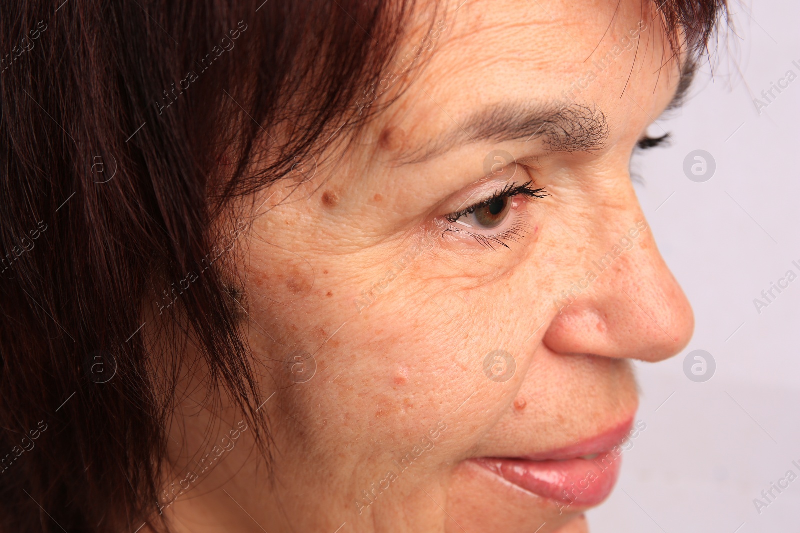 Photo of Skin care. Senior woman on white background, closeup