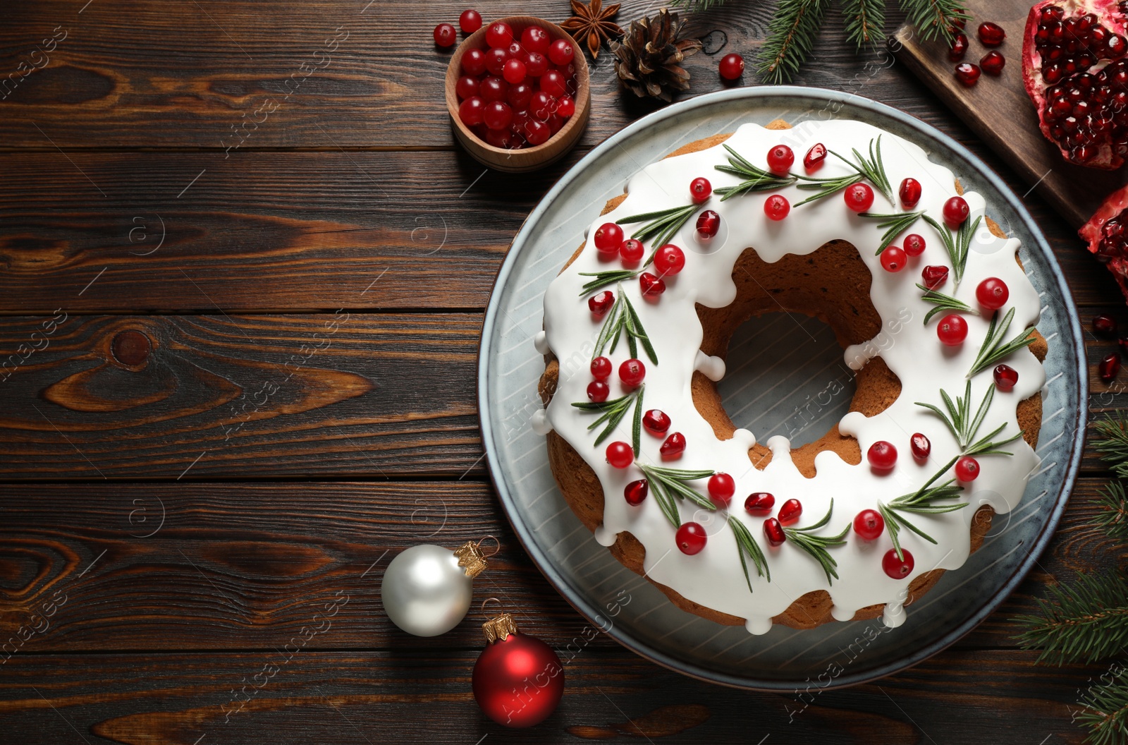 Photo of Flat lay composition with traditional Christmas cake and decorations on wooden table, space for text