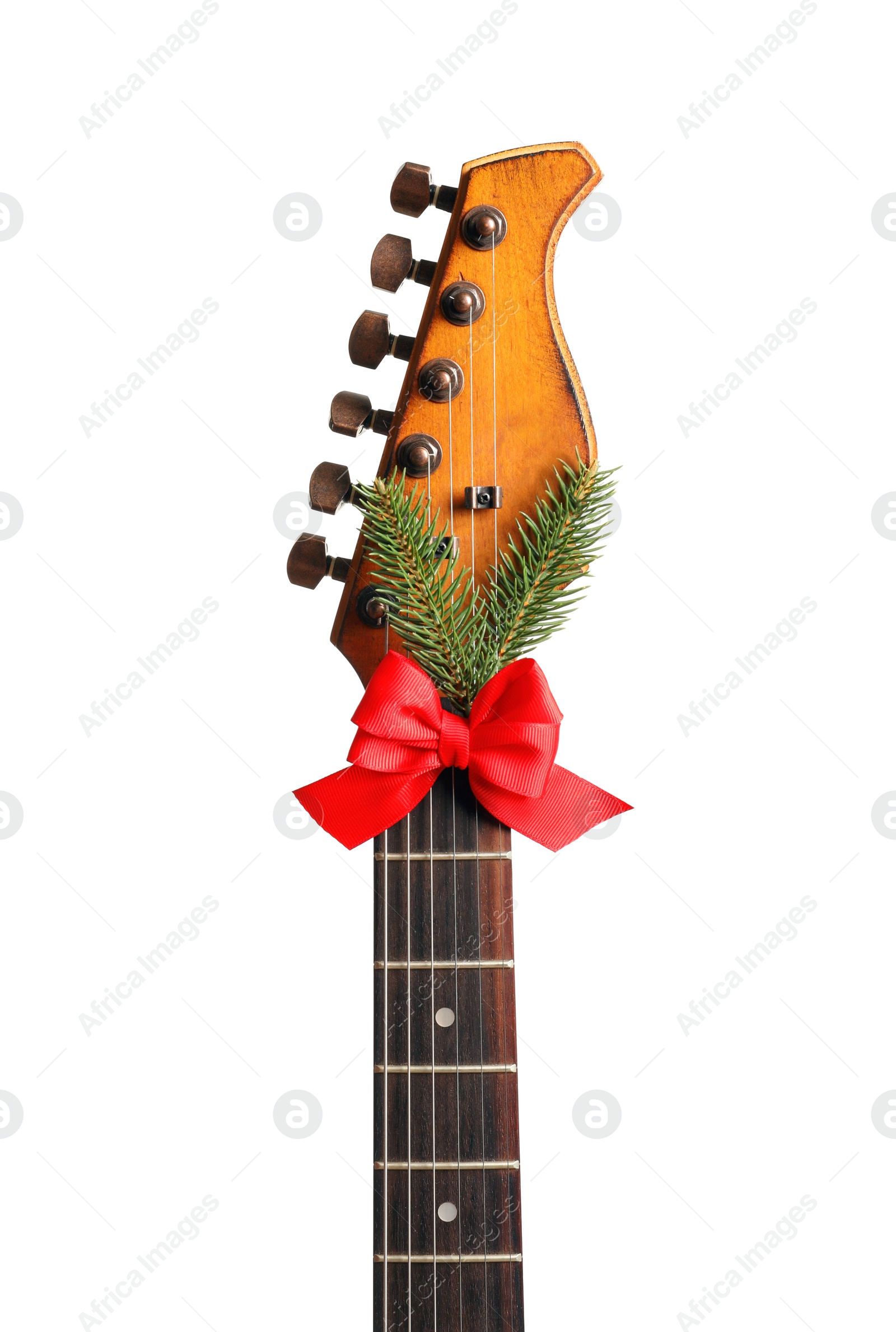 Photo of Guitar with bow and fir tree twig on white background. Christmas music concept