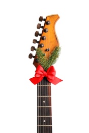 Photo of Guitar with bow and fir tree twig on white background. Christmas music concept