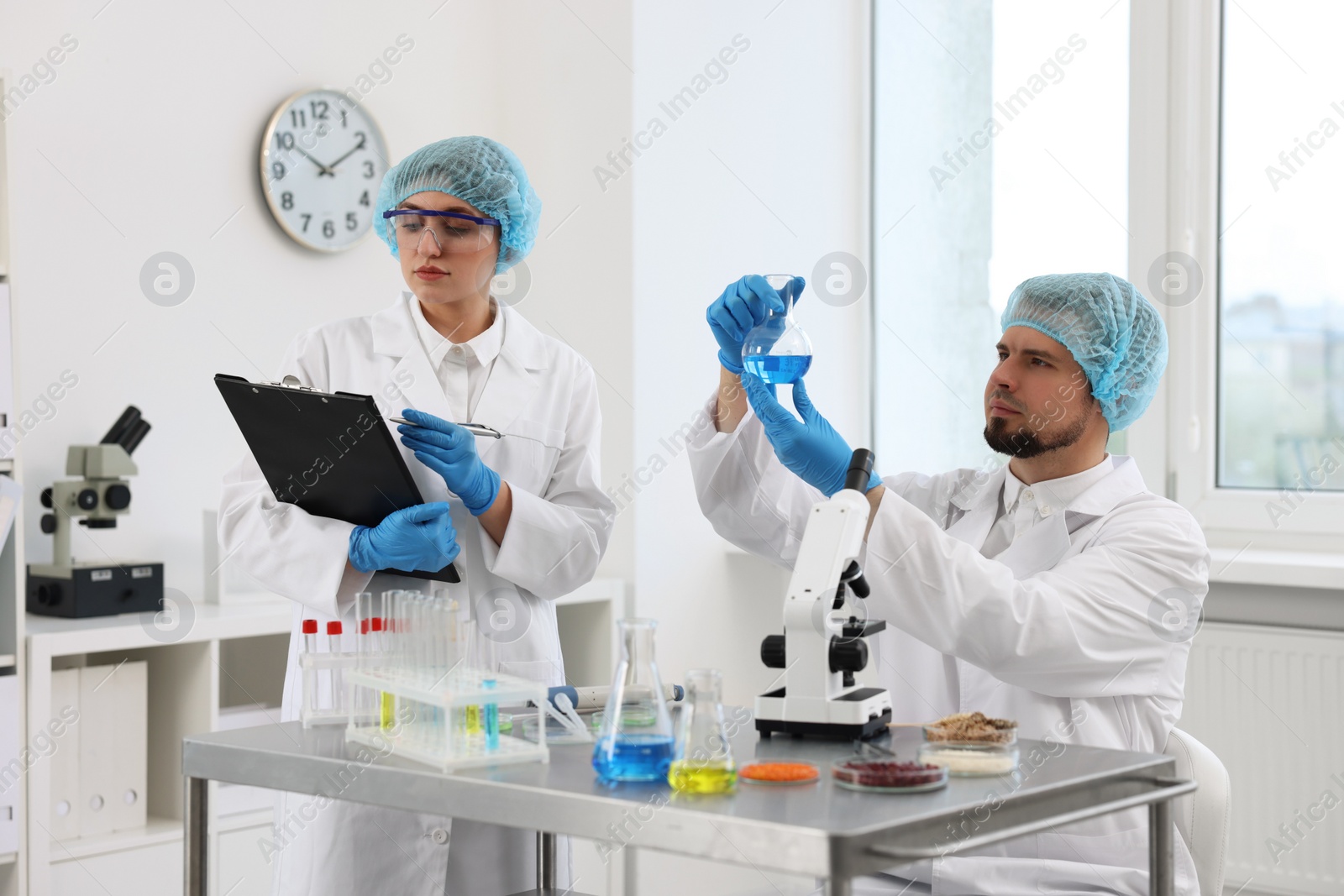 Photo of Quality control. Food inspectors checking safety of products in laboratory