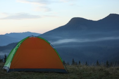 Photo of Camping tent in mountains on early morning