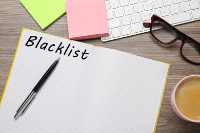 Image of Word Blacklist written in notepad, computer keyboard and paper notes on wooden table, flat lay