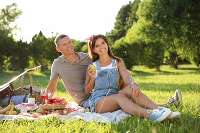 Photo of Happy couple having picnic in park on sunny day