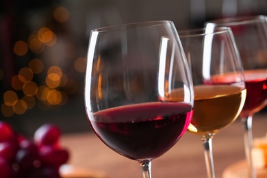 Photo of Glasses with different wines against blurred background, closeup