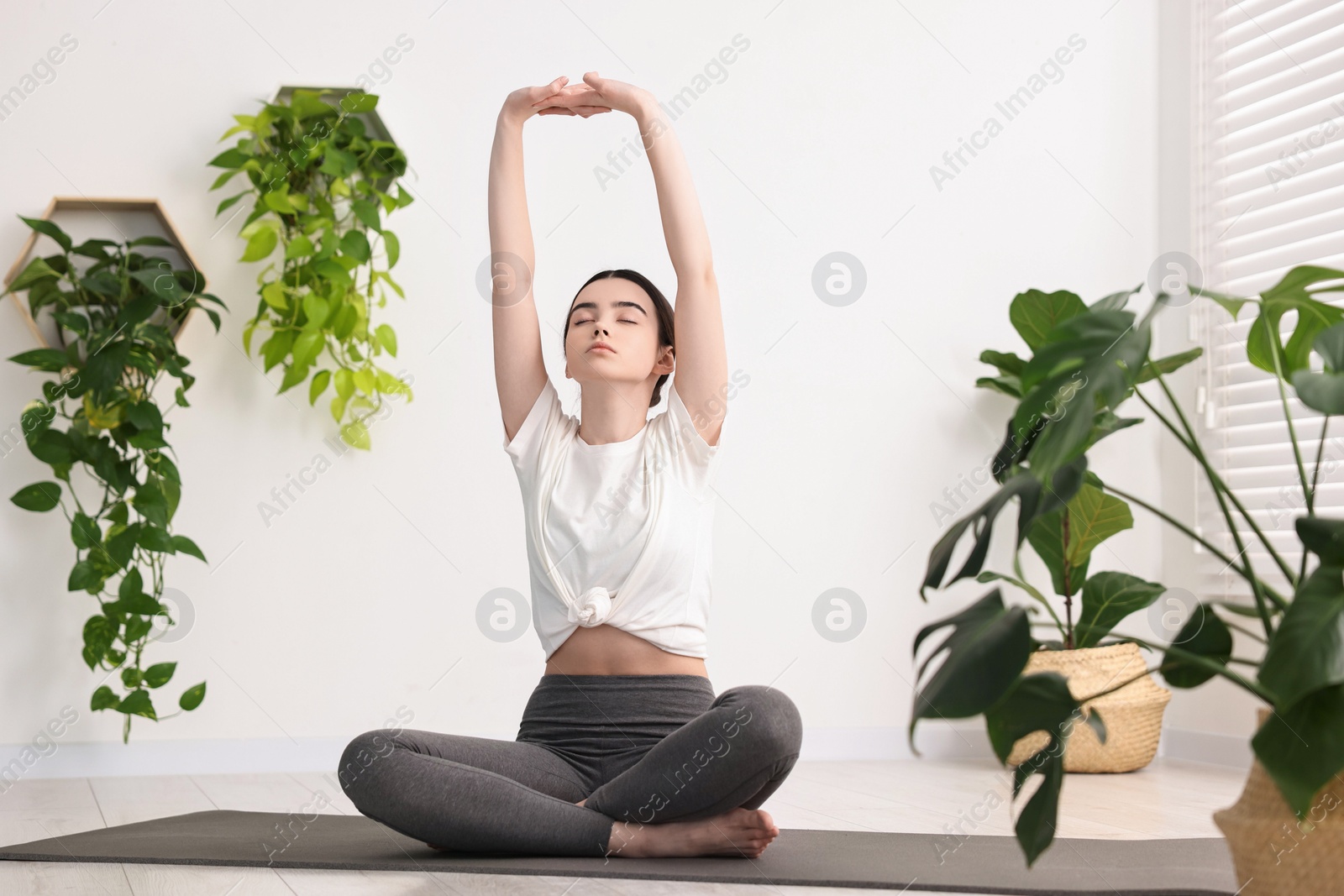 Photo of Beautiful girl meditating on mat in yoga studio