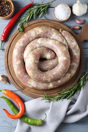 Flat lay composition with homemade sausages and products on light grey wooden table