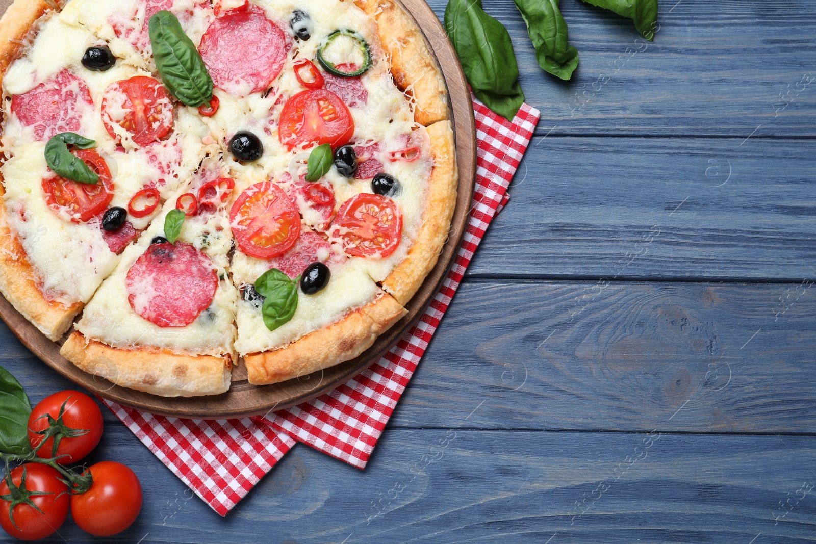 Photo of Flat lay composition with delicious pizza Diablo on wooden background. Space for text