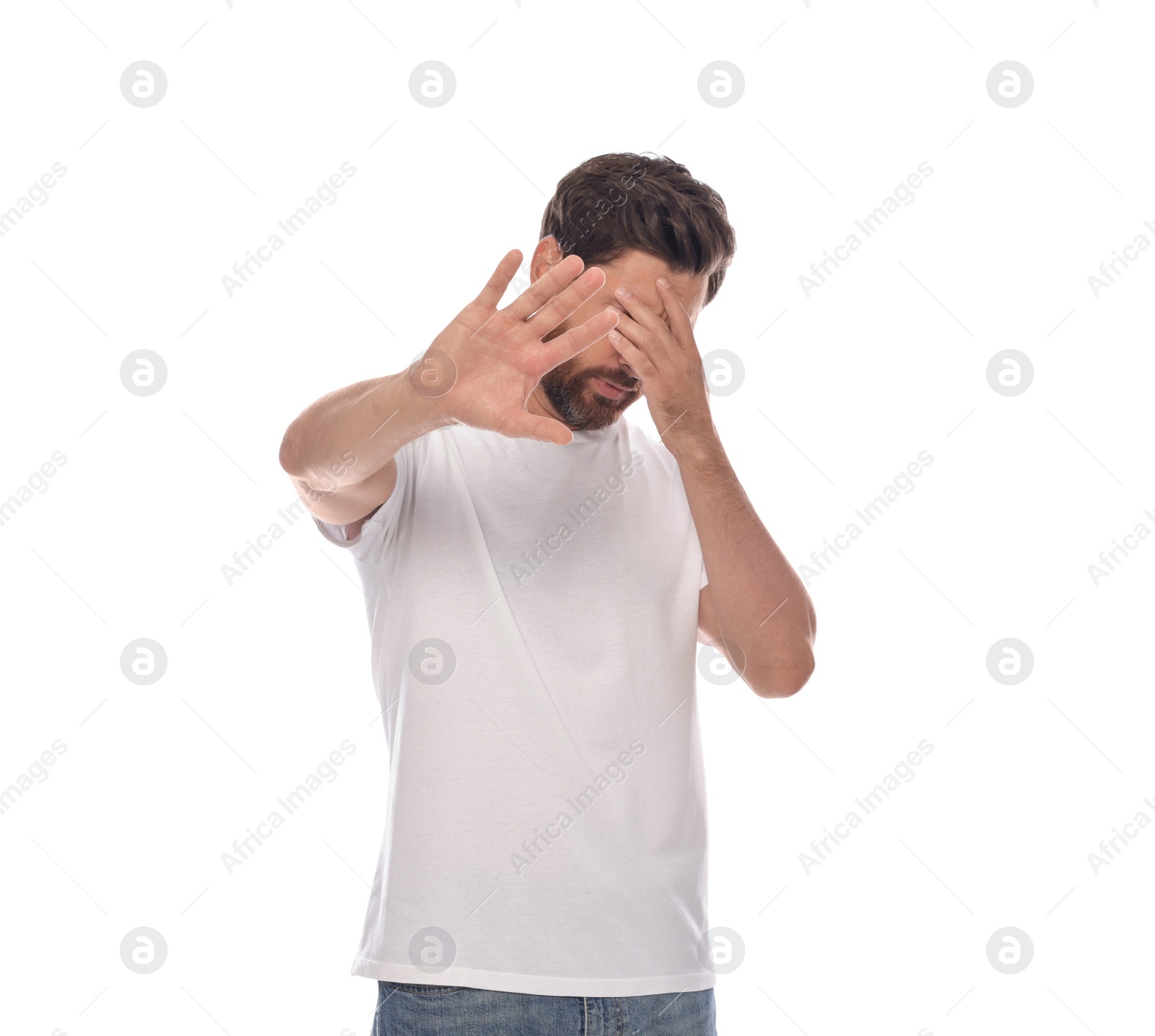 Photo of Embarrassed man covering face with hands on white background