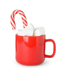 Cup of tasty cocoa with marshmallows and Christmas candy cane isolated on white