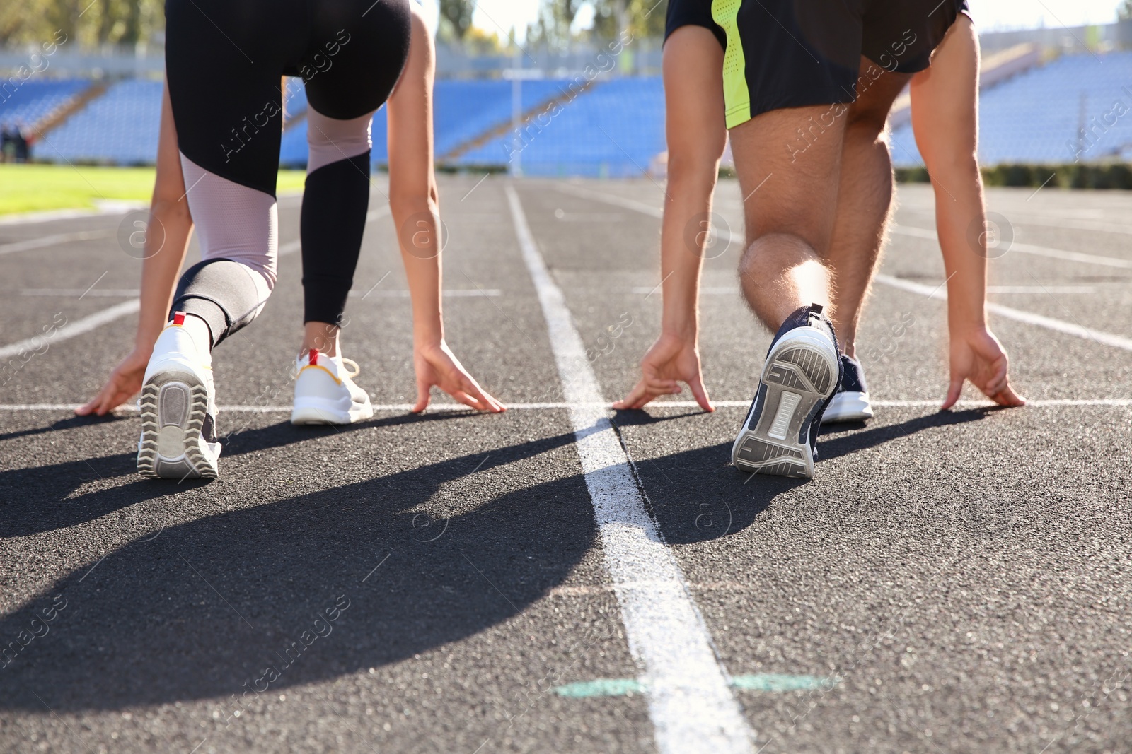 Photo of Sporty couple ready for running at stadium on sunny morning