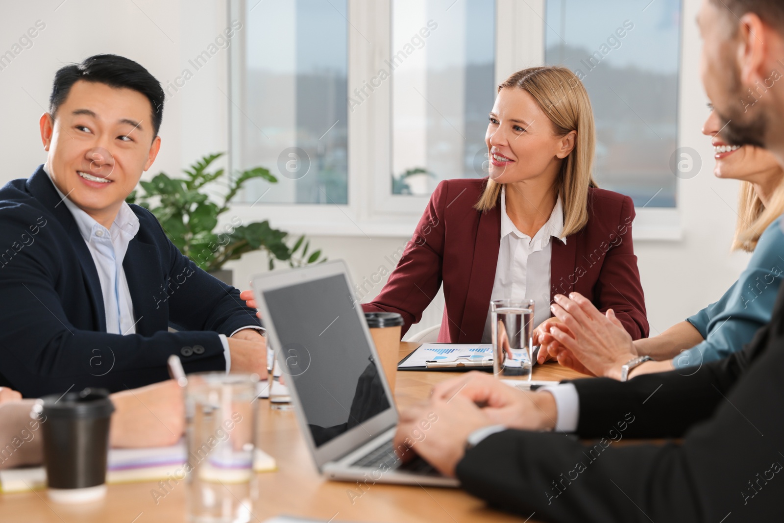 Photo of Businesswoman having meeting with her employees in office