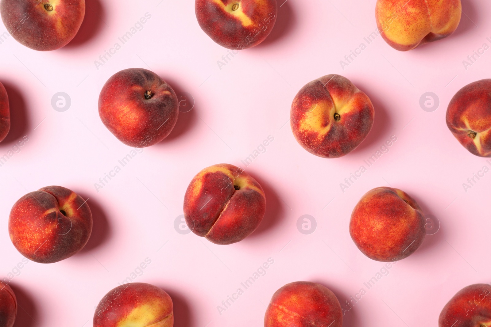 Photo of Flat lay composition with sweet juicy peaches on pink background