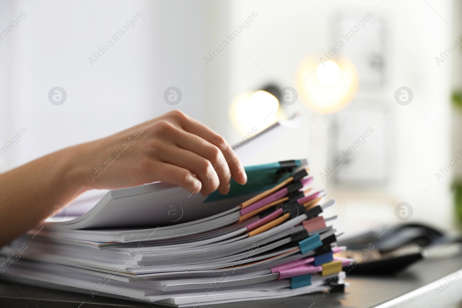 Photo of Office employee working with documents at table, closeup