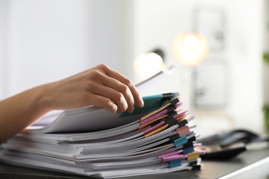 Office employee working with documents at table, closeup