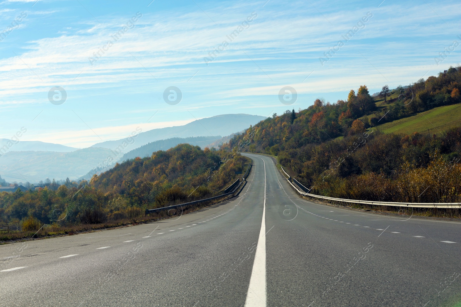 Photo of Landscape with asphalt road leading to mountains