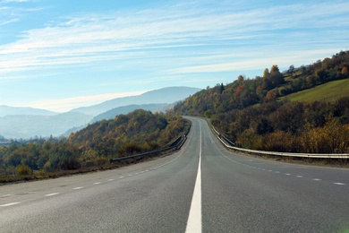 Photo of Landscape with asphalt road leading to mountains