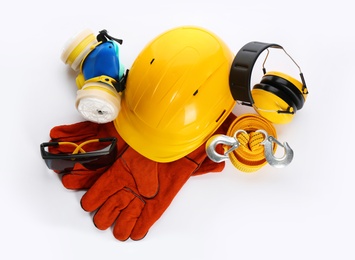 Photo of Protective workwear on white background, top view. Safety equipment