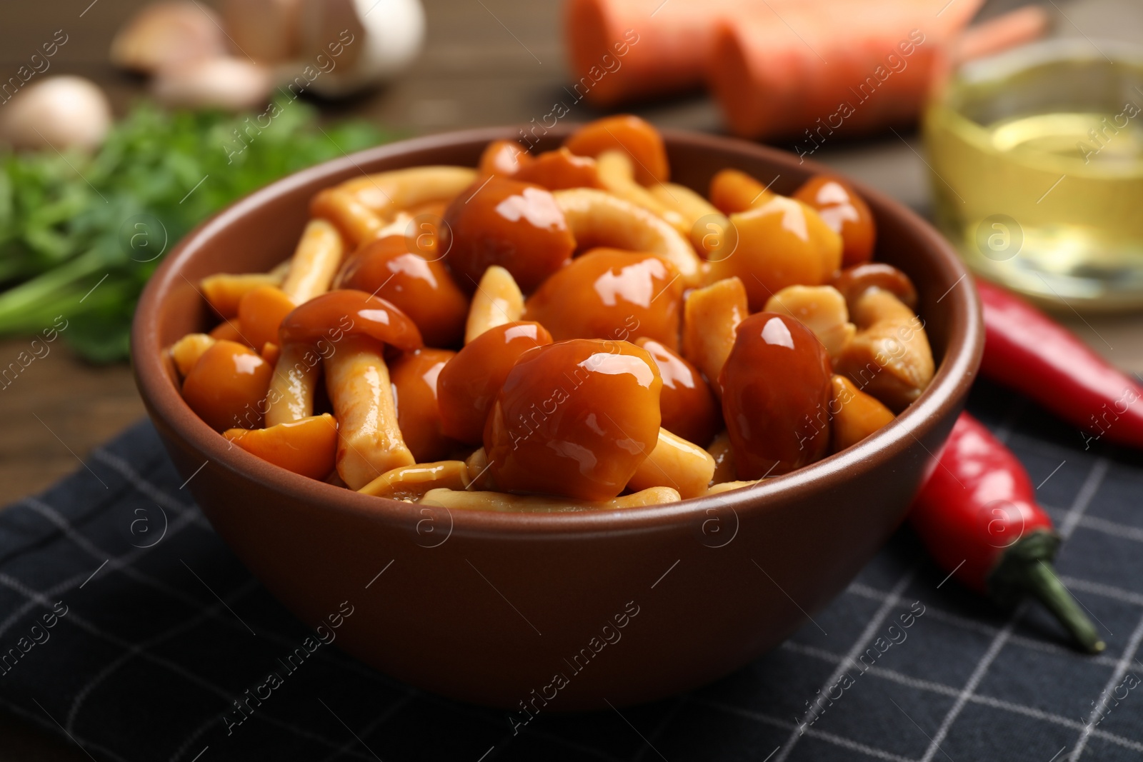 Photo of Tasty marinated mushrooms in bowl on table, closeup