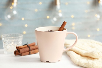 Composition with cup of hot winter drink on table. Cozy season