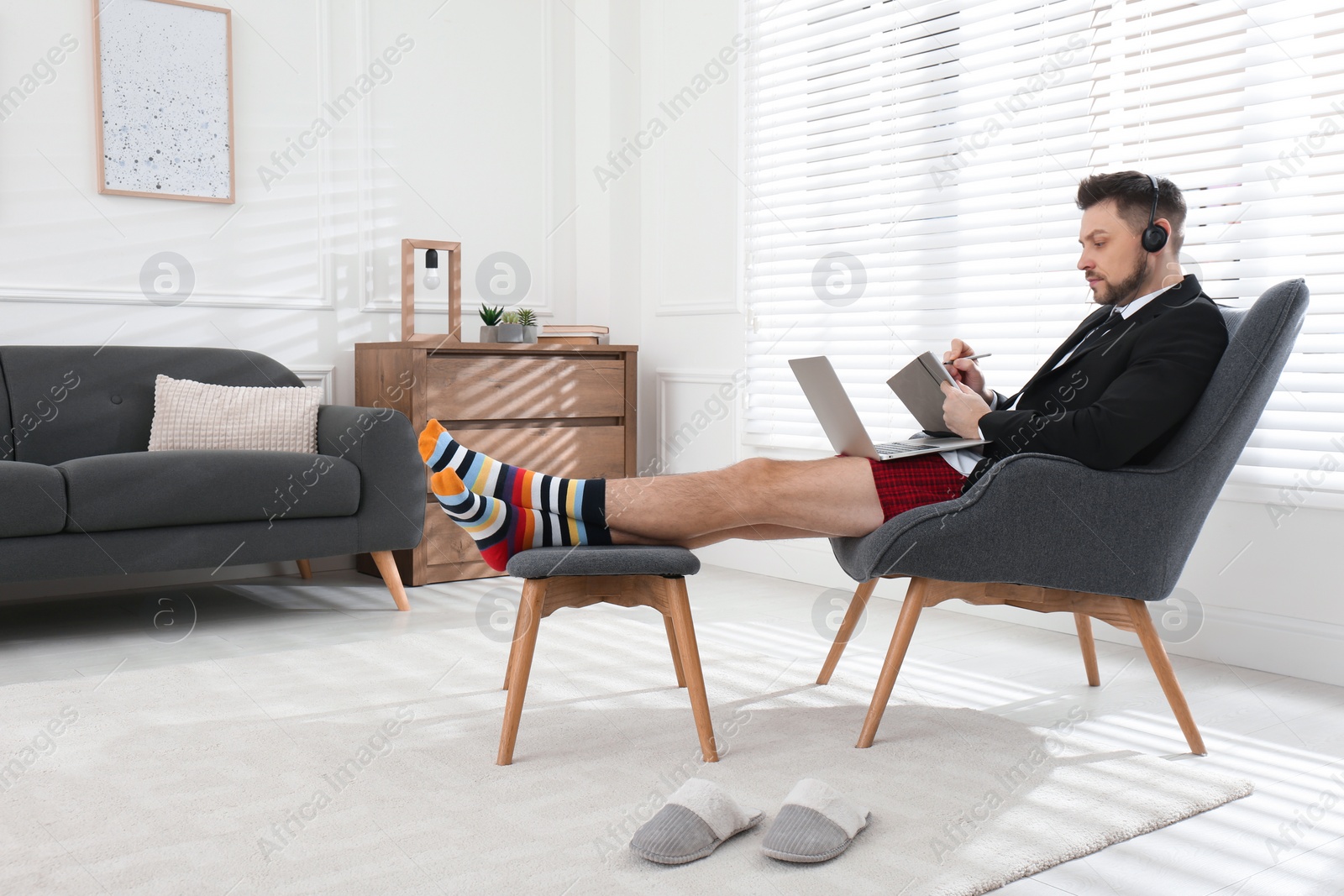 Photo of Businessman in underwear pretending to wear formal clothes during video call at home