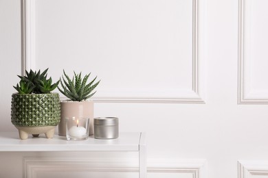 Photo of Beautiful Haworthia and Aloe in pots on white table, space for text. Different house plants