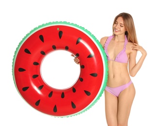 Beautiful young woman in stylish bikini with watermelon inflatable ring on white background