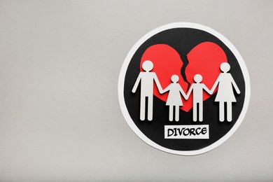 Photo of Word Divorce, broken heart and paper cutout of family on light grey background, flat lay with space for text