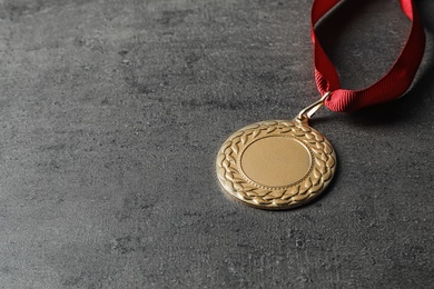 Gold medal with space for design on grey background. Victory concept